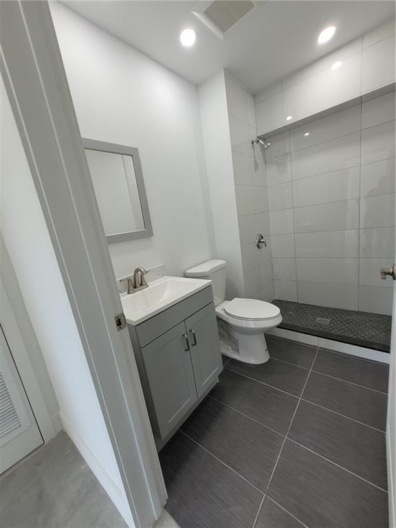 6041 Southwest 17th Street Miami, FL 33155 - Photo 16 of 26 a bathroom with a double vanity sink toilet and a shower