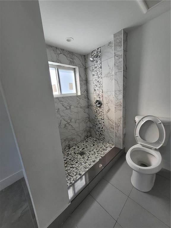 6041 Southwest 17th Street Miami, FL 33155 - Photo 8 of 26 a bathroom with a toilet and a shower