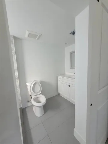 a white toilet sitting next to a bathroom sink