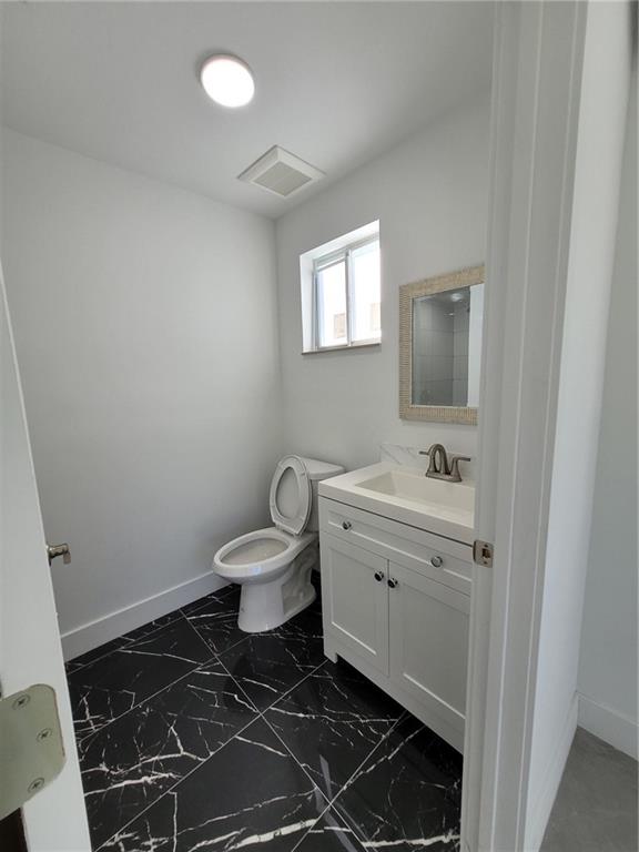 6041 Southwest 17th Street Miami, FL 33155 - Photo 10 of 26 a bathroom with a toilet a sink and mirror