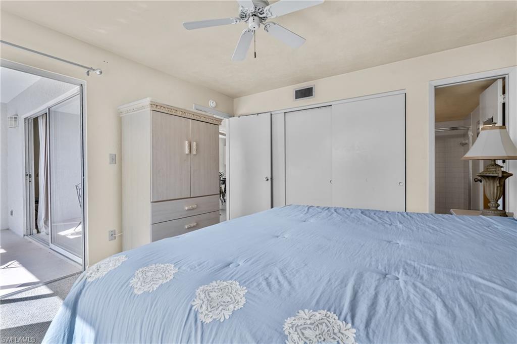 2155 San Marco Road, Unit 2204 Marco Island, FL 34145 - Photo 16 of 22 a bedroom with a bed and a chandelier