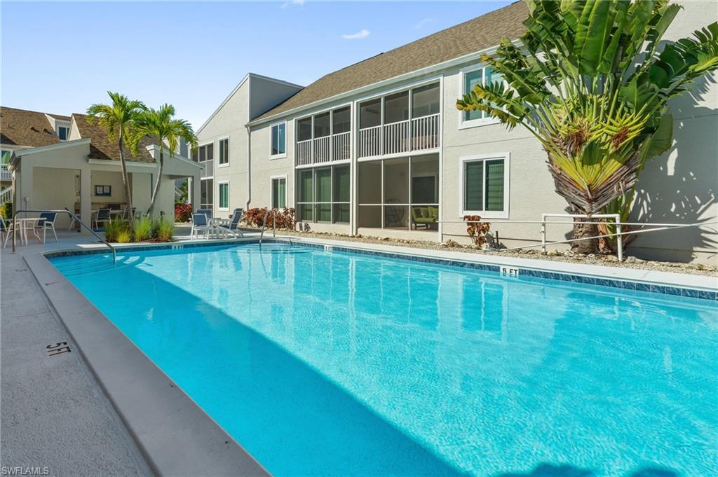 2155 San Marco Road, Unit 2204 Marco Island, FL 34145 - Photo 18 of 22 a swimming pool with outdoor seating and yard