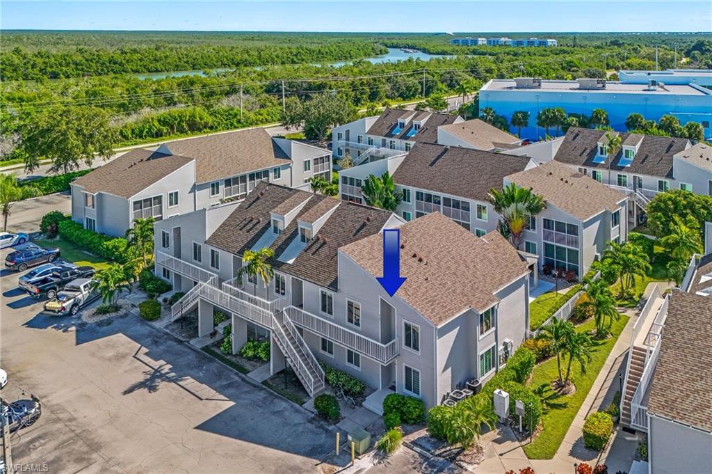 2155 San Marco Road, Unit 2204 Marco Island, FL 34145 - Photo 20 of 22 an aerial view of multiple houses with a yard