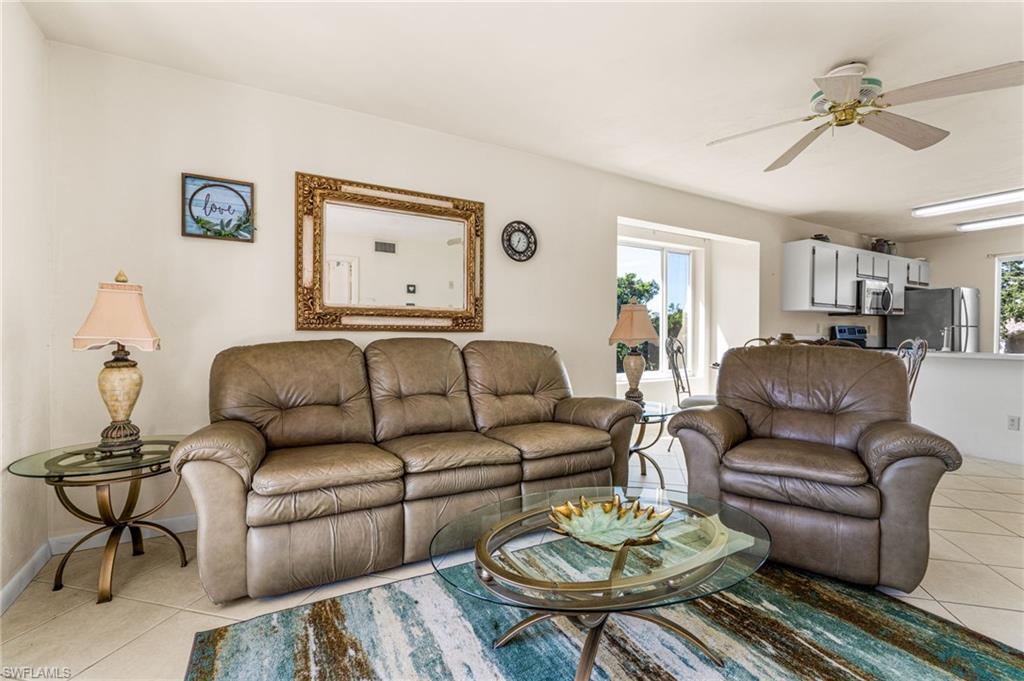 2155 San Marco Road, Unit 2204 Marco Island, FL 34145 - Photo 7 of 22 a living room with furniture and a table
