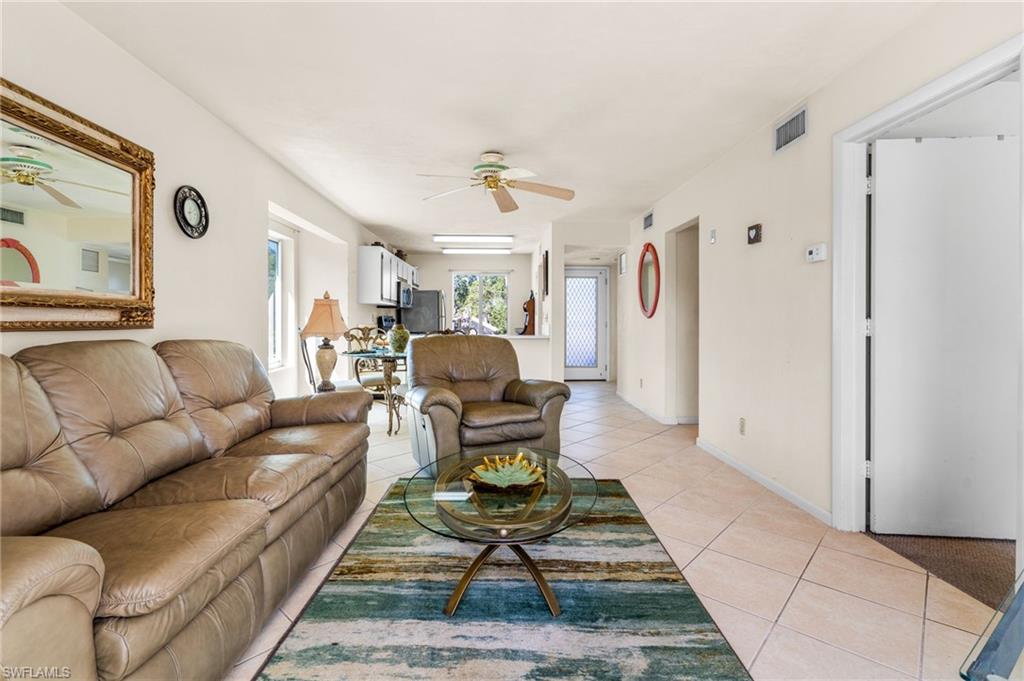 2155 San Marco Road, Unit 2204 Marco Island, FL 34145 - Photo 8 of 22 a living room with furniture a rug and white walls