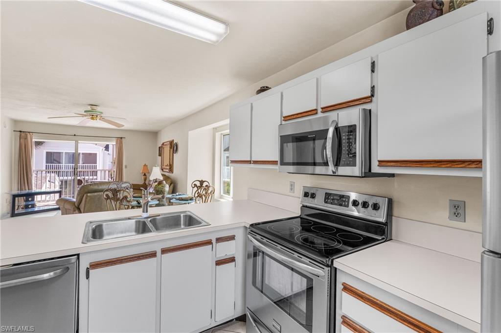2155 San Marco Road, Unit 2204 Marco Island, FL 34145 - Photo 10 of 22 a kitchen with a stove and a microwave