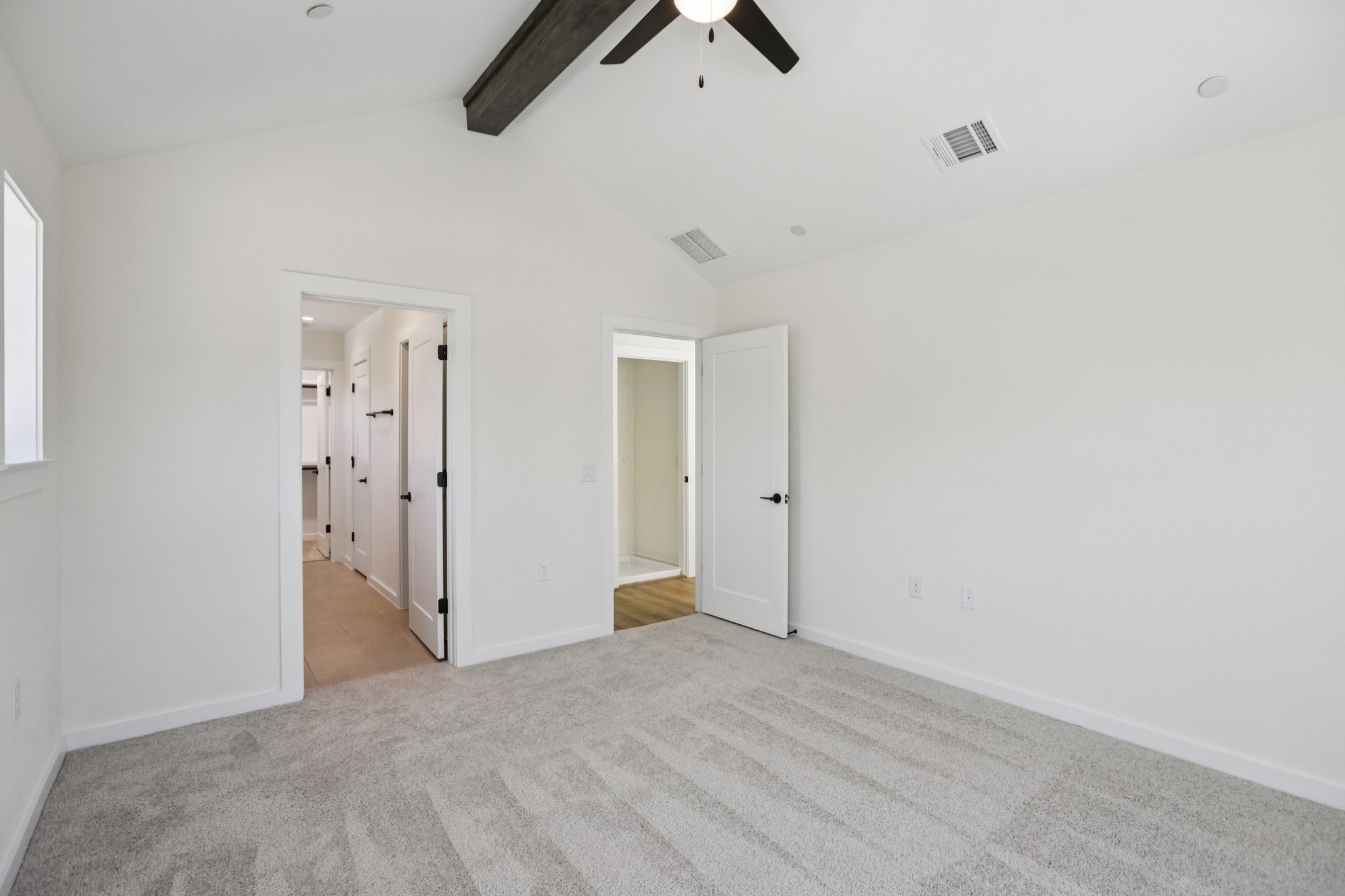 2414 Drew Lane, Unit 5 Austin, TX 78748 - Photo 17 of 24 Unfurnished bedroom featuring light carpet, a ceiling fan, and ensuite bath