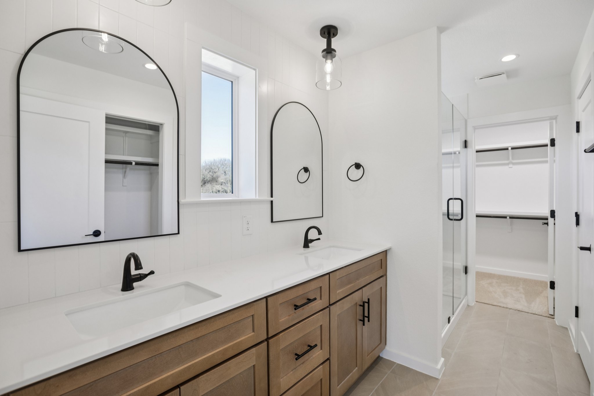 2414 Drew Lane, Unit 5 Austin, TX 78748 - Photo 18 of 24 Bathroom featuring a walk in closet, double vanity, recessed lighting, a shower stall, and light tile patterned flooring