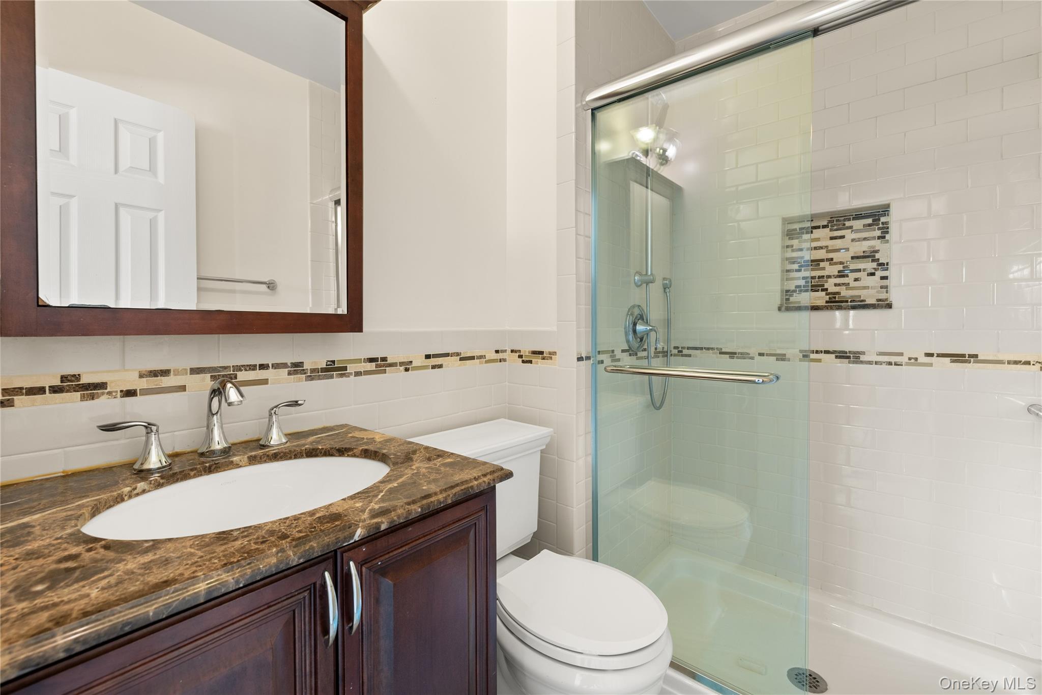 650 Newbridge Road, Unit 15 East Meadow, NY 11554 - Photo 14 of 20 a bathroom with a granite countertop sink toilet and shower