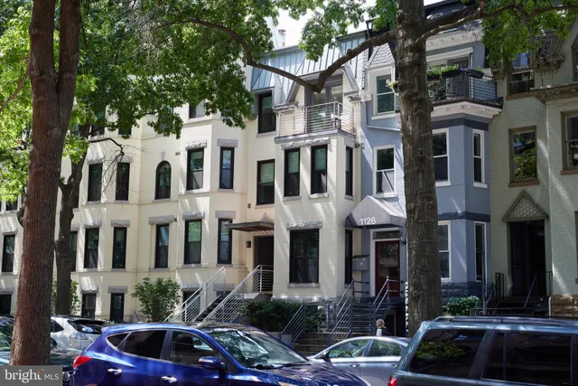 a view of a street that has couple of cars parked on the road