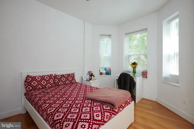 a bedroom with a bed and window