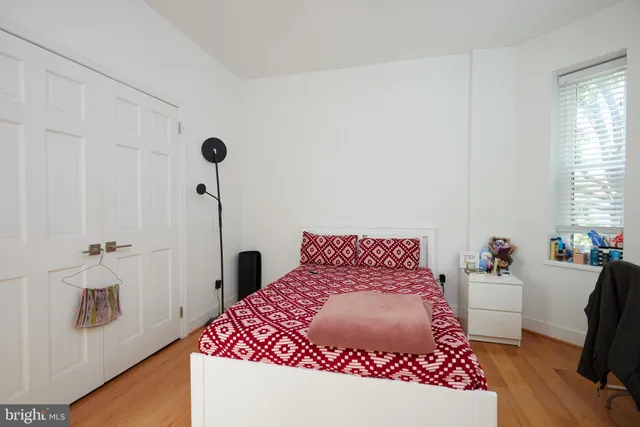 a bedroom with a bed dresser and a window