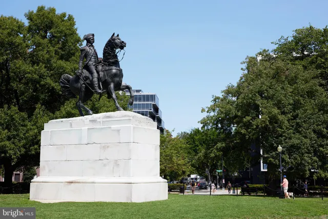 a view of a patio with a table and chairs under an umbrella with a small yard