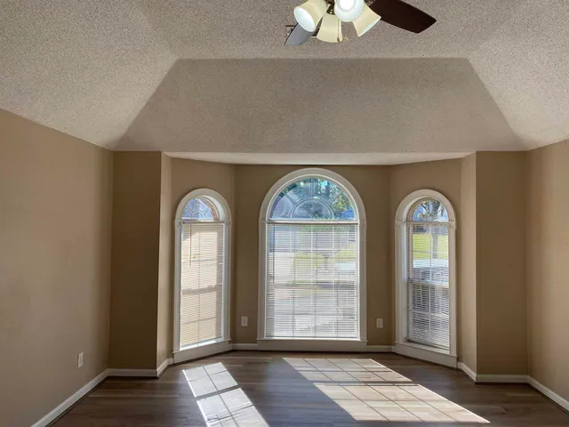 a view of an entryway door with a chandelier