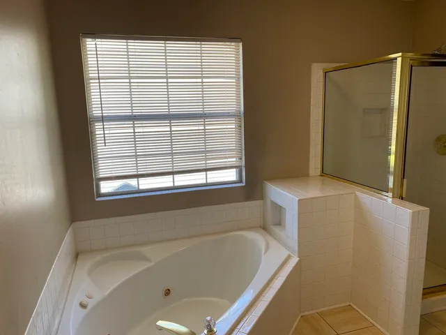 a bathroom with a bathtub and a shower