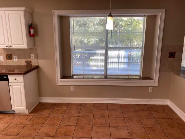 a view of a kitchen with a sink and a window