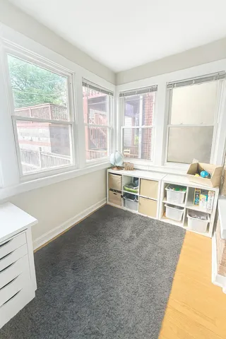 a living room with furniture and next to a large window