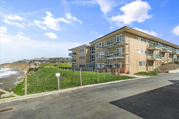 a view of a garden with a building in the background