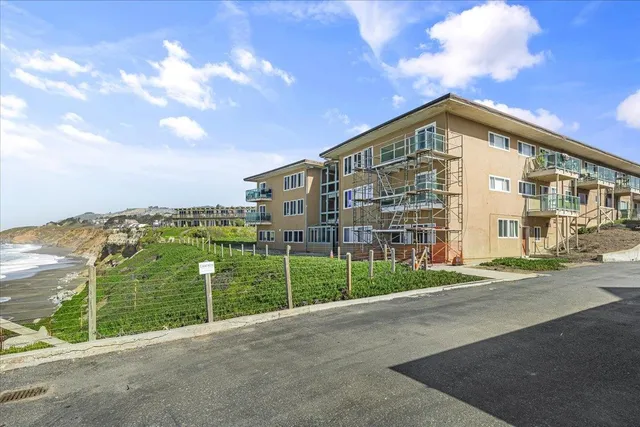 a view of a garden with a building in the background