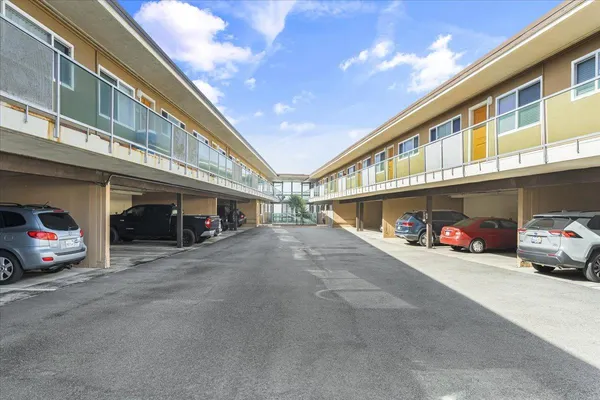 a view of a cars park in front of building