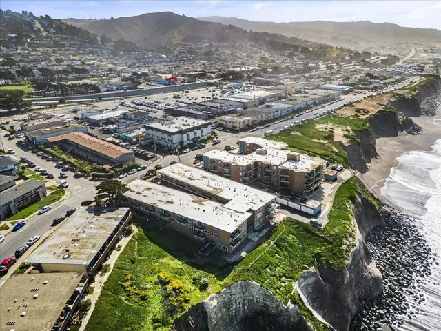 an aerial view of residential houses with outdoor space