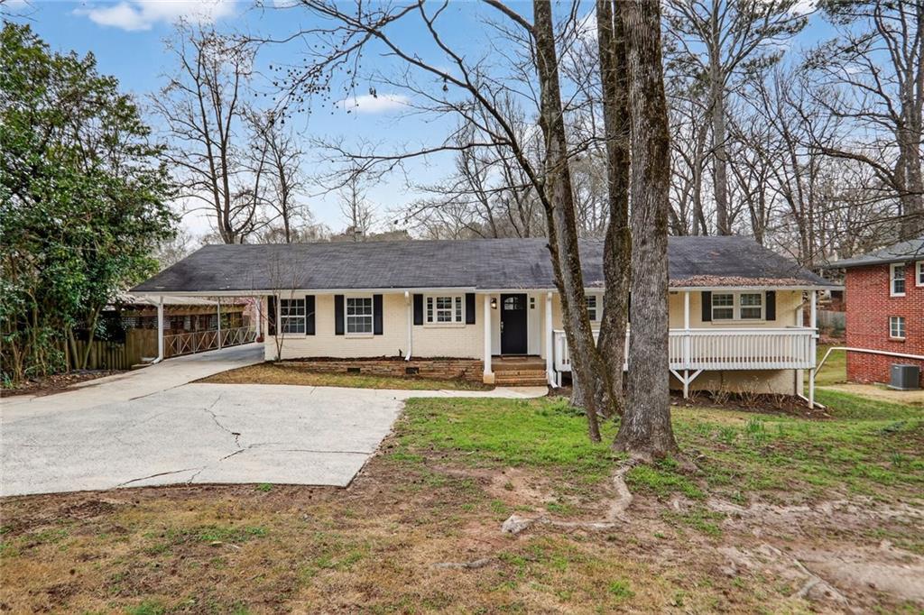 1127 Moores Mill Road Northwest Atlanta, GA 30327 - Photo 1 of 20 front view of a house with a yard