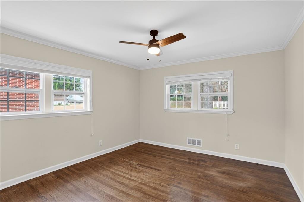 1127 Moores Mill Road Northwest Atlanta, GA 30327 - Photo 14 of 20 a view of empty room with wooden floor and fan