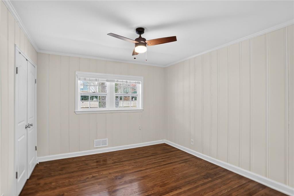 1127 Moores Mill Road Northwest Atlanta, GA 30327 - Photo 15 of 20 wooden floor in an empty room with a window