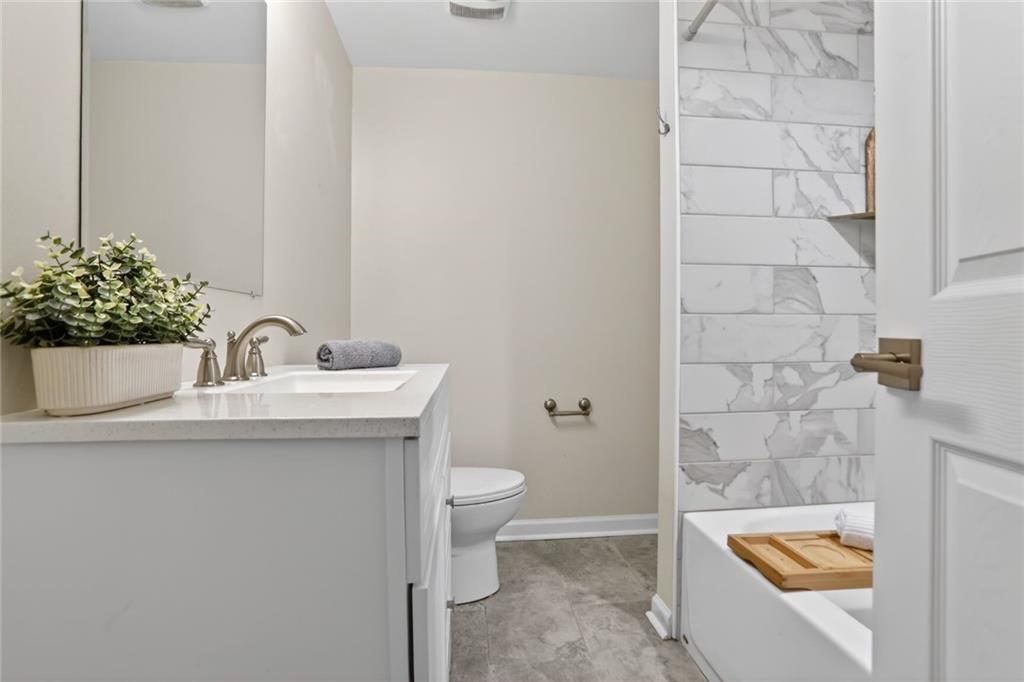 1127 Moores Mill Road Northwest Atlanta, GA 30327 - Photo 16 of 20 a bathroom with a sink a toilet and shower