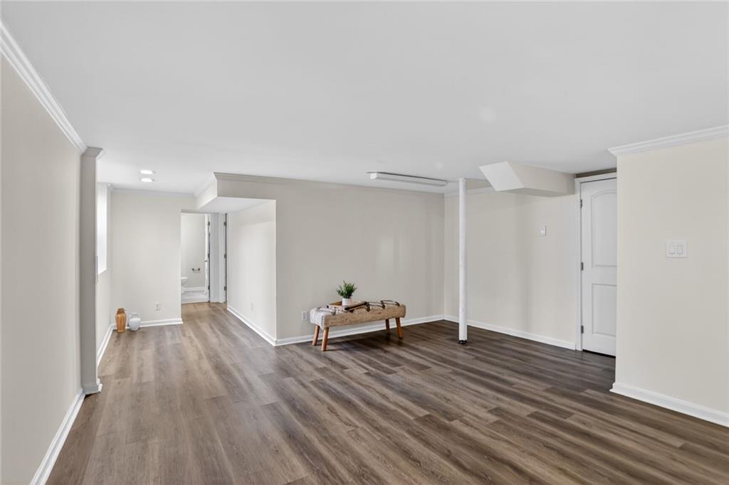 1127 Moores Mill Road Northwest Atlanta, GA 30327 - Photo 17 of 20 a view of a room with wooden floor and a window