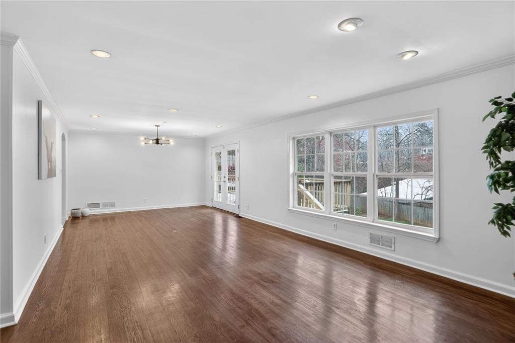 1127 Moores Mill Road Northwest Atlanta, GA 30327 - Photo 9 of 20 a view of empty room with wooden floor and fan
