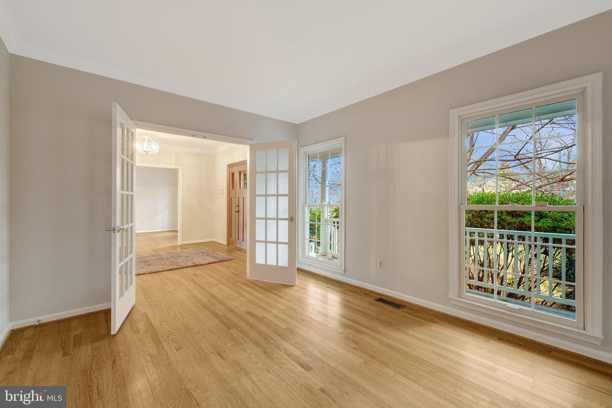 11273 Waples Mill Road Oakton, VA 22124 - Photo 32 of 75 a view of an empty room with wooden floor and a window