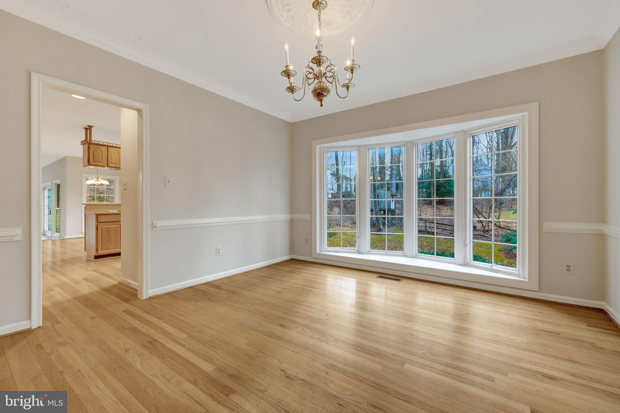 11273 Waples Mill Road Oakton, VA 22124 - Photo 37 of 75 a view of an empty room with wooden floor and a window
