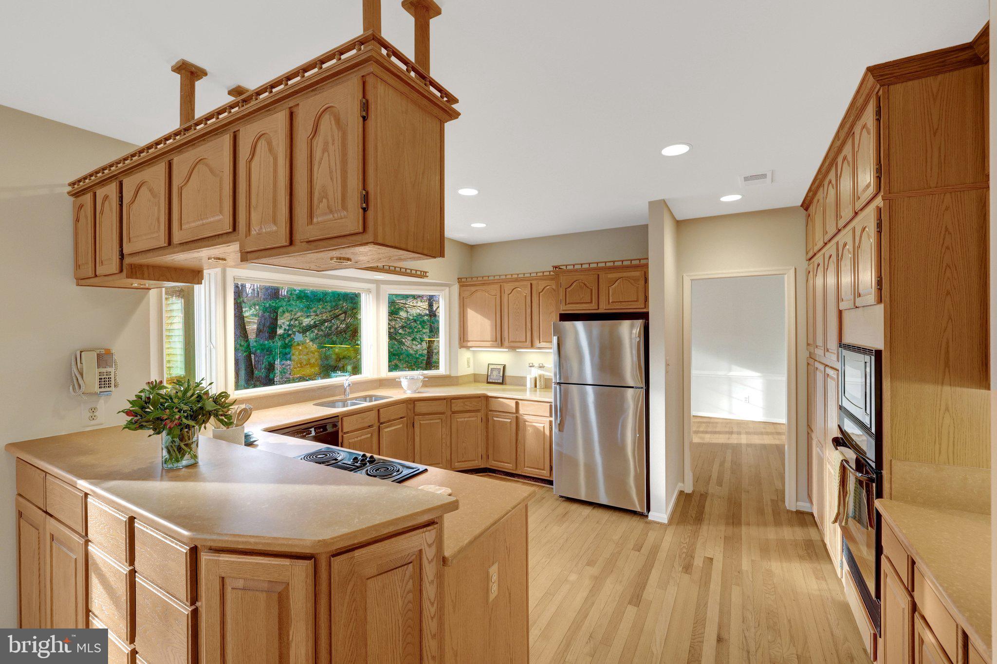11273 Waples Mill Road Oakton, VA 22124 - Photo 39 of 75 a kitchen with stainless steel appliances granite countertop a refrigerator a sink and a stove