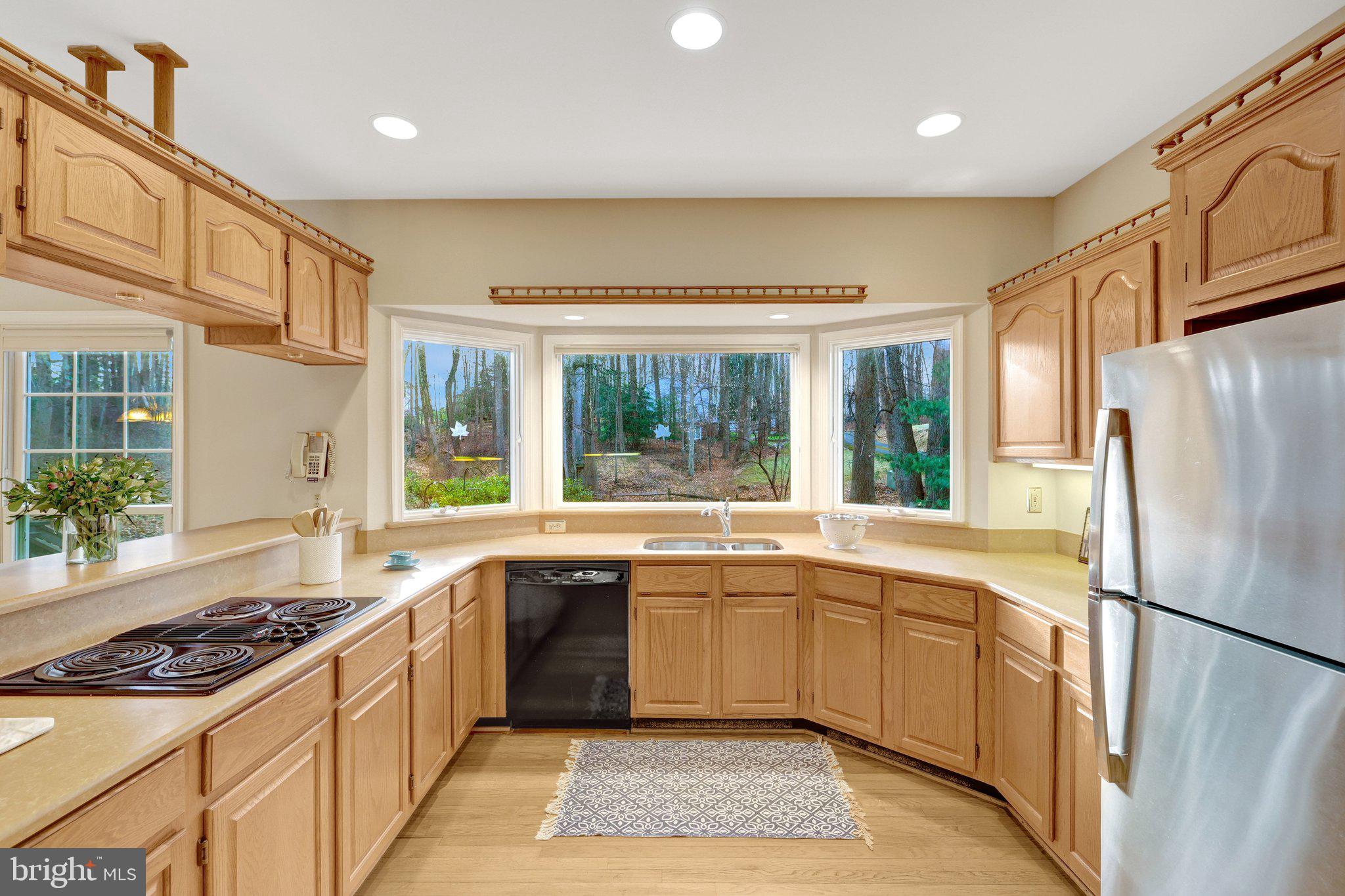 11273 Waples Mill Road Oakton, VA 22124 - Photo 40 of 75 a kitchen with a sink stove and refrigerator