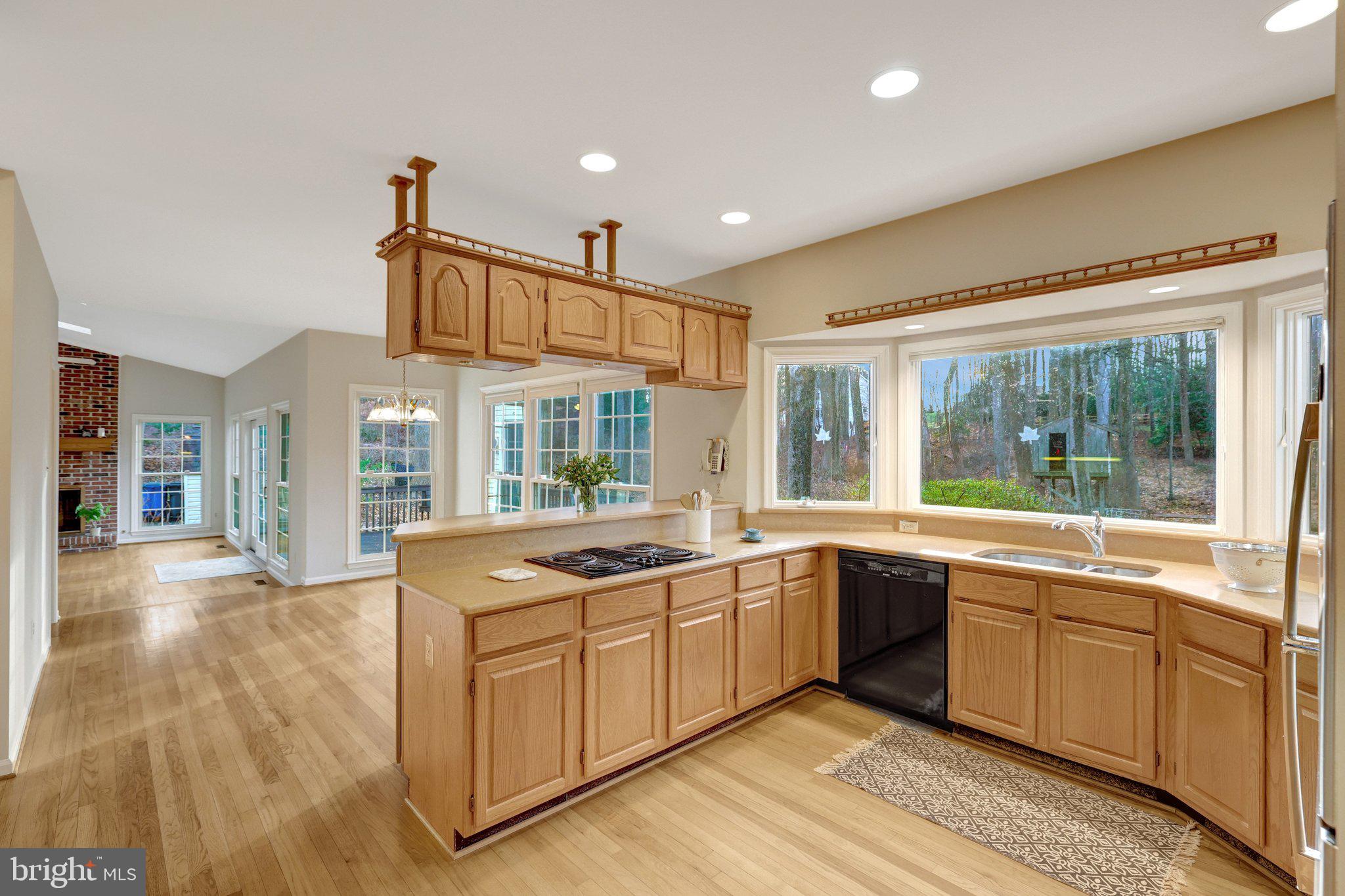 11273 Waples Mill Road Oakton, VA 22124 - Photo 41 of 75 a large kitchen with stainless steel appliances granite countertop a sink and cabinets with wooden floor