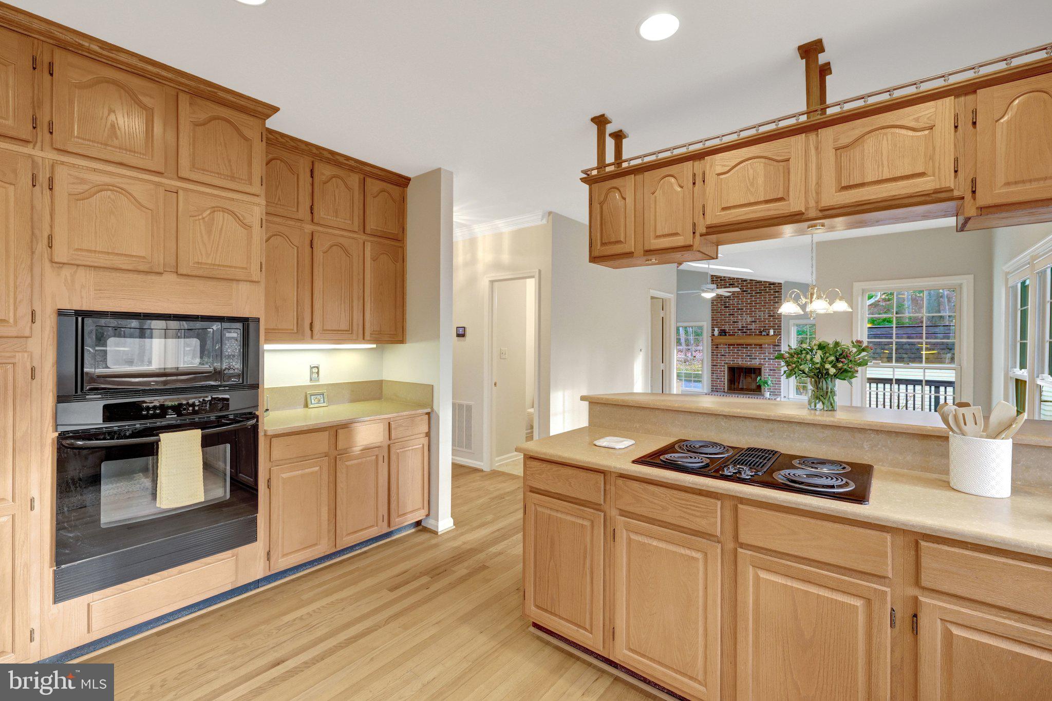 11273 Waples Mill Road Oakton, VA 22124 - Photo 42 of 75 a kitchen with stainless steel appliances granite countertop a stove a sink and a microwave