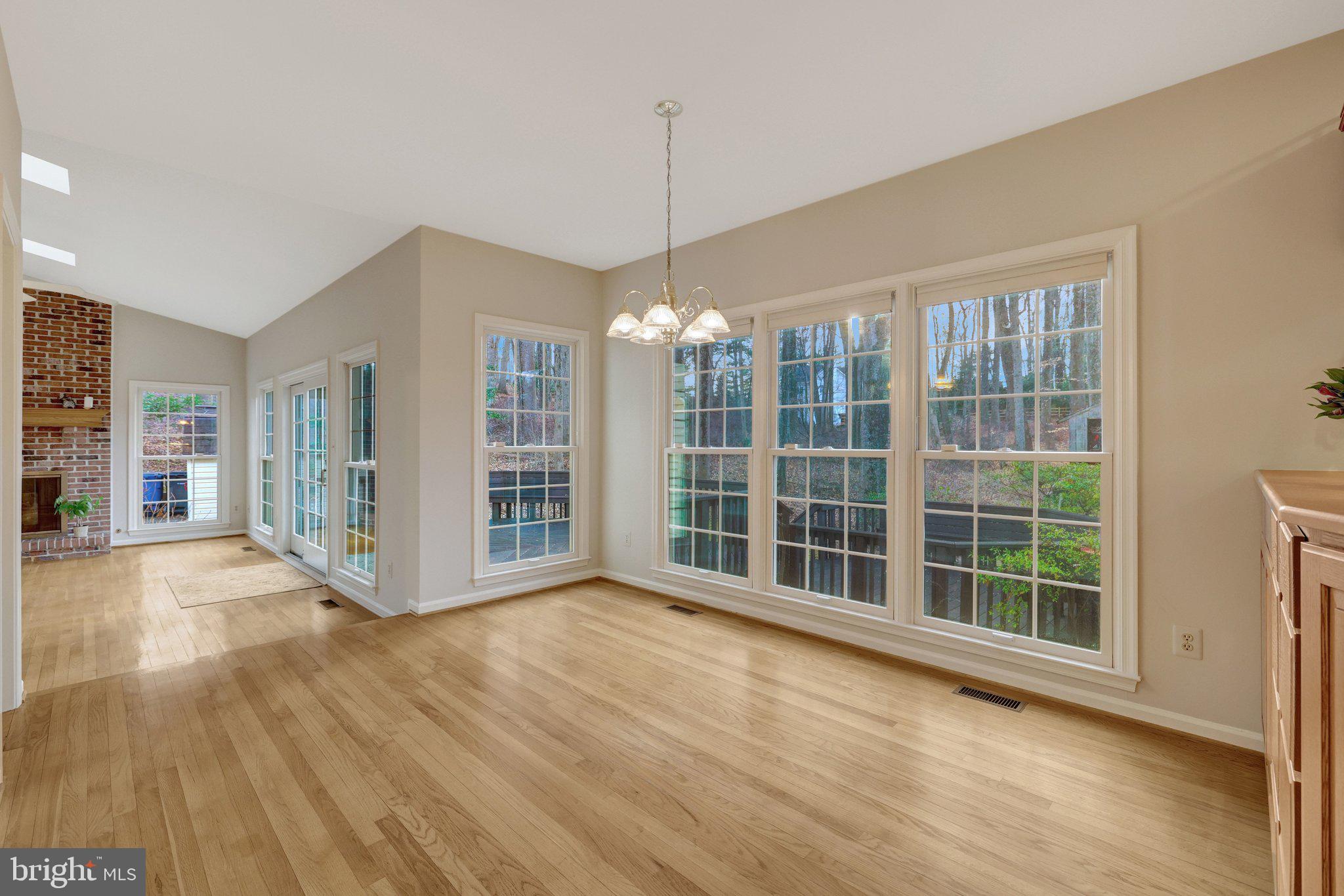 11273 Waples Mill Road Oakton, VA 22124 - Photo 45 of 75 a view of an empty room with wooden floor and a window