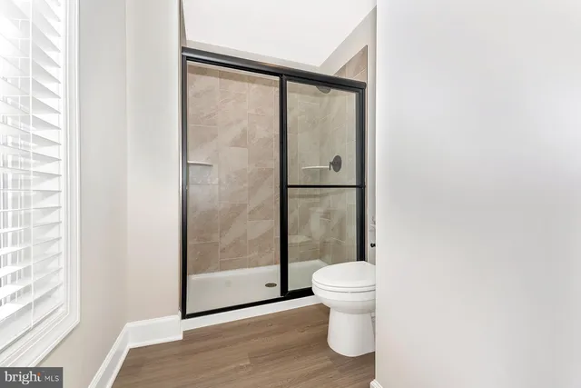 a bathroom with a toilet and a shower