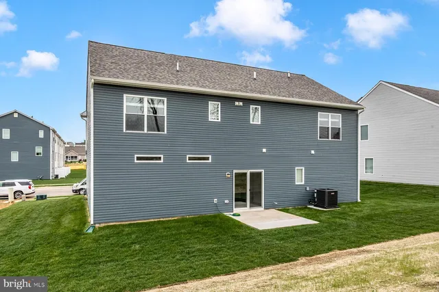 a brick house that is sitting in the grass