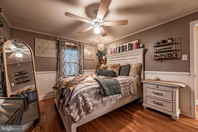 a bedroom with a bed dresser and a window
