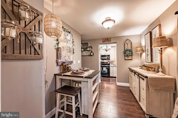a kitchen with stainless steel appliances granite countertop a stove and a wooden floors