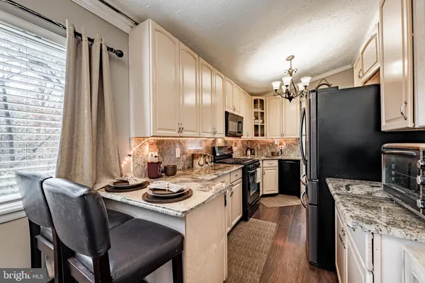a kitchen with a table chairs stove and refrigerator