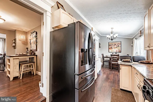 a kitchen with stainless steel appliances a refrigerator stove and sink