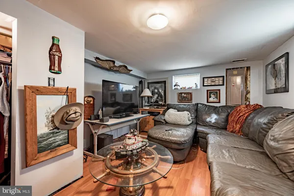a living room with furniture a rug and a flat screen tv