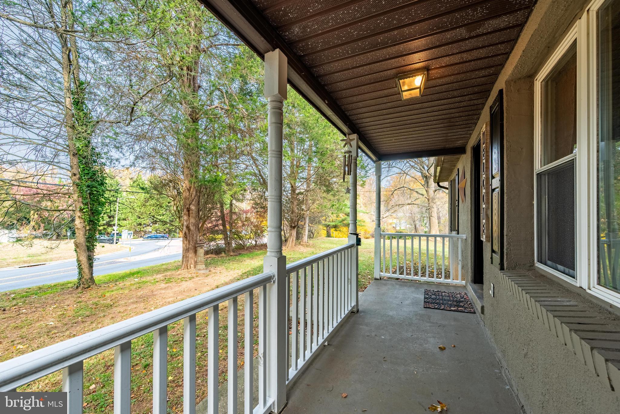211 East Wheel Road Abingdon, MD 21009 - Photo 4 of 27 a view of porch with green trees in front of main door