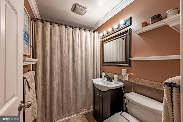 a bathroom with a sink a mirror and a toilet