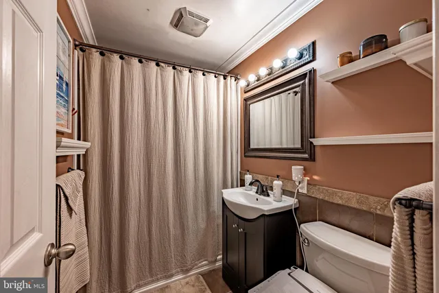 a bathroom with a sink a mirror and a toilet