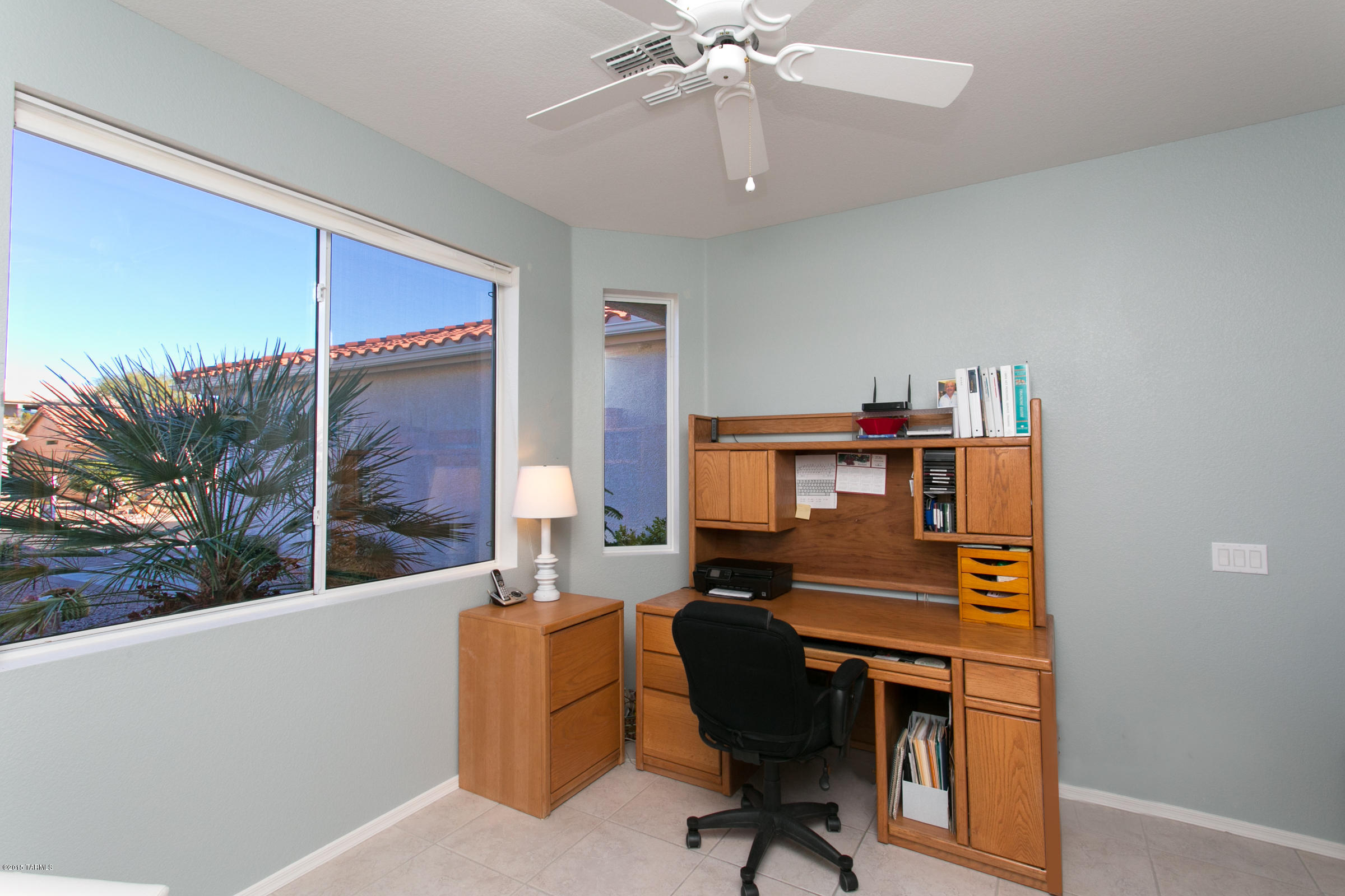 62419 East Northwood Road Tucson, AZ 85739 - Photo 5 of 30 a view of a workspace with furniture and a window