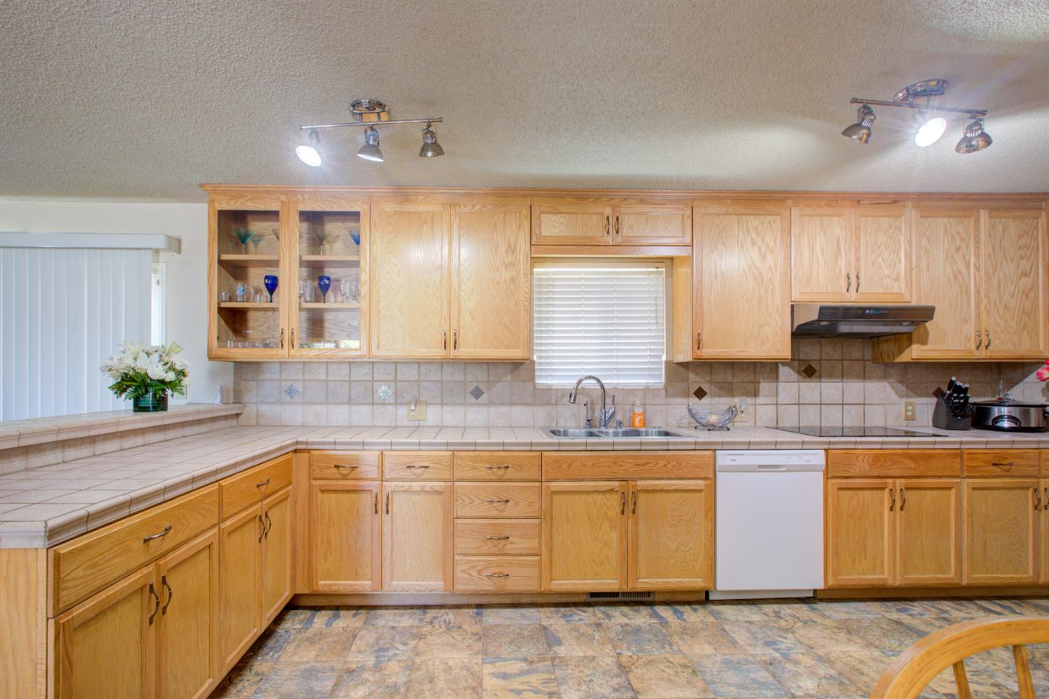 2982 Sequoia Drive Merced, CA 95340 - Photo 12 of 33 a kitchen with a sink stove and cabinets